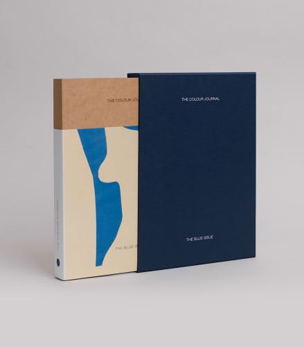 Photograph of the Blue issue of The Colour Journal, which features an abstract blue and beige cover design, jutting out from a navy blue slip case