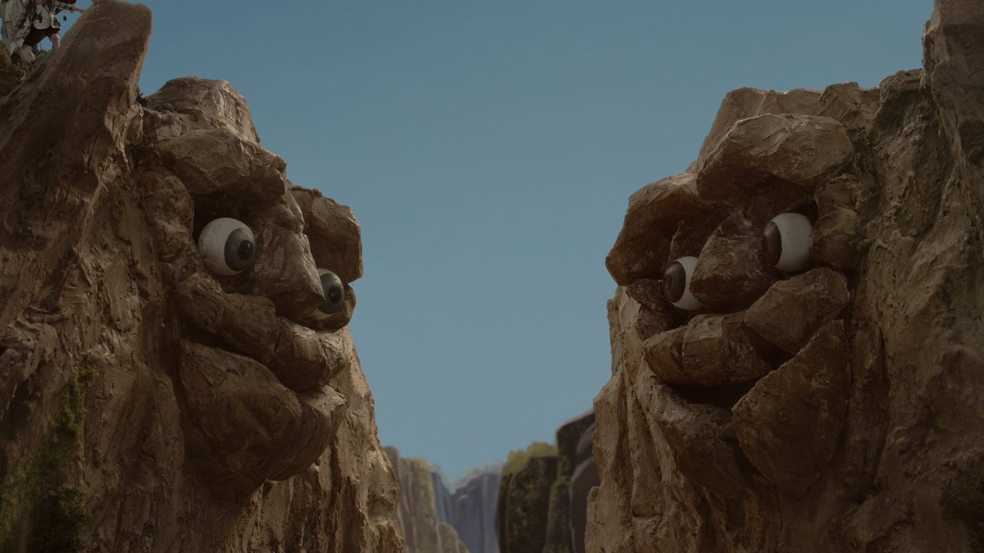 Still image of two mountains with faces looking at each other, from an animated campaign to promote travel to Oregon by Wieden + Kennedy Portland